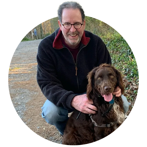 Gary Williams smiling with his dog